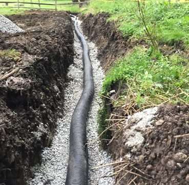 french drain before the corrugated pipe has been coverd with back fill