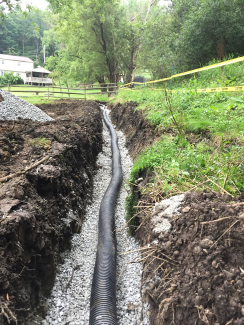 french drain before the corrugated pipe has been coverd with back fill